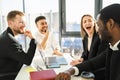 Group of laughing corporation employees at a meeting in the office. Royalty Free Stock Photo