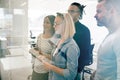 Group of laughing coworkers high fiving during an office meeting