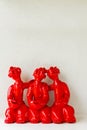 A group of laughing red ceramic doll on white background