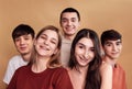 A group of laughing teenagers in casual clothes. The five friends are smiling. Happy girls and boys have fun together. A studio Royalty Free Stock Photo