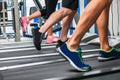 Group of legs wearing sneakers running on