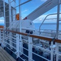 A group of life rafts on a cruise ship in metal containers waiting to deployed in case of an emergency