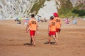 A group of lifeguards patrols the beach