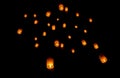 Group of light lamps float up to dark sky for celebration in happiness emotion and relate to new year or good luck for people