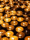 Tea candles in a row burning on black background Royalty Free Stock Photo