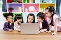 Group of little children diversity watching film together on laptop. Kids playing with laptop computer at home Royalty Free Stock Photo