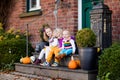 Kids at house porch on autumn day Royalty Free Stock Photo