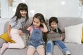 Group of little children watching film movie cartoon together on digital tablet and phone. Kids playing with smartphone