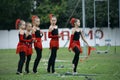 Group of little girls artistic gymnastics in leotards and skirts standing on a stadium before performance. Kyiv, Ukraine