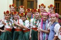 Group of little girls dancers in a native Ukrainian costumes preparing for the performance in a lobby