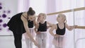 Group of little girls learning new dance moves during ballet lesson