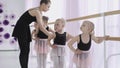 Group of little girls learning new dance moves during ballet lesson