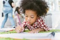 Group of little preschool kids drawing paper with color pencils . portrait of African girl with friends education concept. Royalty Free Stock Photo