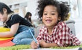 Group of little preschool kids drawing paper with color pencils . portrait of African girl with friends education concept.