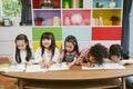 Group of little preschool kids drawing paper with color pencils . portrait of children friends education concept.