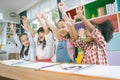 Group of little preschool kids hands up in class . portrait of children diversity education concept.