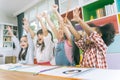Group of little preschool kids hands up in class . portrait of children diversity education concept. Royalty Free Stock Photo