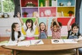 Group of little preschool kids hands up in class . portrait of children diversity education concept. Royalty Free Stock Photo