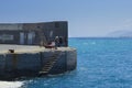 Group of local Greek fishermen on the pier fishing with fishing rods Royalty Free Stock Photo