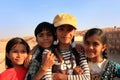 Group of local kids playing near water reservoir, Khichan village, India Royalty Free Stock Photo