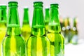 Group of a lot of green bottle beers with a blurry background