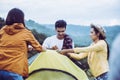 Group of lover Traveller friends putting up a tent at rainforest together,Enjoying camping concept Royalty Free Stock Photo