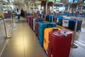 Group of luggage lining up at an international airport check-in counter