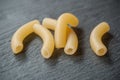 Group of macaroni pasta on chalkboard background