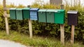 Group of mail - post boxes on wooden sticks outdoors in Norway