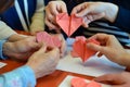 group making heartshaped origamis for a workshop