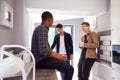 Group Of Male College Students In Shared House With Hot Drinks In Kitchen Hanging Out Together Royalty Free Stock Photo