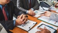 Group of male entrepreneurs discussing management project during working together and analyzing accounting trade and experience in