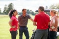 Group Of Male And Female Golfers Standing By Golf Buggy On Course Royalty Free Stock Photo