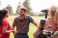 Group Of Male And Female Golfers Standing By Golf Buggy On Course Royalty Free Stock Photo