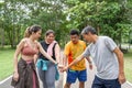 A group of 2 male and 2 female runners putting their hands togeter to celebrate their running success at running track of a local Royalty Free Stock Photo