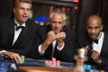 Group of male friends gambling at roulette table