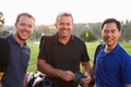 Group Of Male Golfers Marking Scorecard At End Of Round