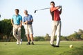 Group Of Male Golfers Teeing Off