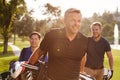 Group Of Male Golfers Walking Along Fairway Carrying Bags Royalty Free Stock Photo