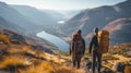 Group of male hikers admiring a scenic view from a mountain top. Adventurous young men with backpacks. Hiking and trekking on a