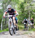 Group of male mountain bike cyclists in the forest