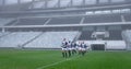 Group of male rugby players entering stadium in a row for match