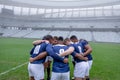 Group of male rugby players forming huddles in the morning Royalty Free Stock Photo