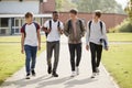 Group Of Male Teenage Students Walking Around College Campus