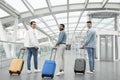 Group Of Male Tourists Walking With Suitcases Posing In Airport Royalty Free Stock Photo