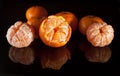 Group of mandarins with reflection on black background