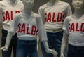 group of mannequins wearing a white t-shirt with written sales showcases to warn customers about discounts.