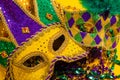 Group of Mardi Gras Masks on yellow Background wtih beads