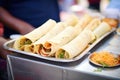 group of masala dosas arranged in a dosa stand