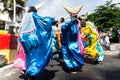 Group of masked people are dancing in the street during the pre-carnival Fuzue parade